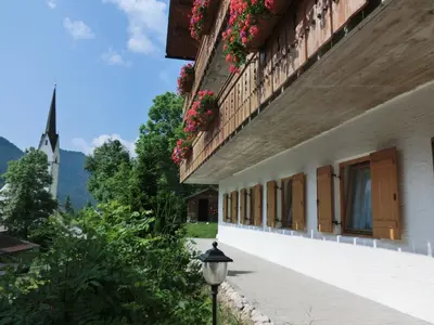 a building with flowers on the windows and a street light at Apartments Sotbosch in La Villa