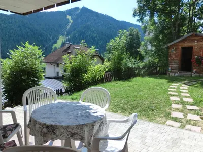 a table and chairs on a patio with a view at Apartments Sotbosch in La Villa