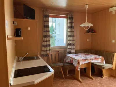 a small kitchen with a table and a sink at Alpen Ferienwohnung IV in Lappago