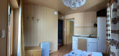 a room with a kitchen with a sink and a counter at Alpen Ferienwohnung IV in Lappago