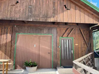 a wooden building with two doors and a porch at Alpen Ferienwohnung IV in Lappago