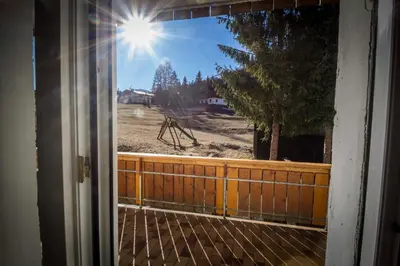 an open door with a view of a yard at Casa per Ferie Le Rais in Pozza di Fassa