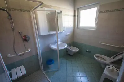 a bathroom with a shower and a sink and a toilet at Casa per Ferie Le Rais in Pozza di Fassa