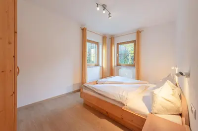 a bedroom with a bed and a window at Weinhof am See in Caldaro