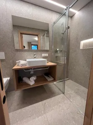 a bathroom with a sink and a shower at Moserhof in Marlengo