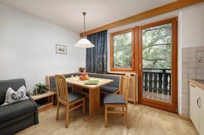 a kitchen and dining room with a table and chairs at Moserhof in Marlengo