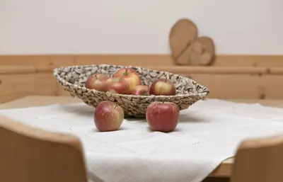 a bowl of apples sitting on top of a table at Perlhof in Schenna