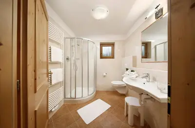 a bathroom with a shower and a sink and a toilet at Perlhof in Schenna