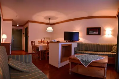 a living room with a couch and a tv at Appartamenti Astoria La Villa in La Villa