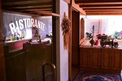 a restaurant with a table and a sign that reads restaurantarma at Appartamenti Astoria La Villa in La Villa