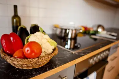 a basket of vegetables on a counter in a kitchen at Villa Trogerhof in Ora/Auer