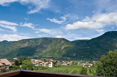 a town in a valley with mountains in the background at Pension Stamserhof in Nalles