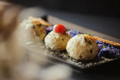 a plate of food with sushi on top of it at Hotel Corno Bianco in Nova Ponente