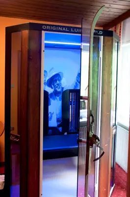a glass elevator with a screen in a room at Haus Christian in Nova Levante