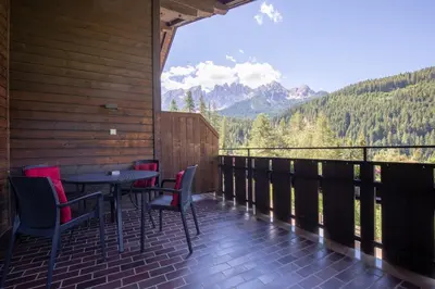 a balcony with a table and chairs and a view at Haus Christian in Nova Levante