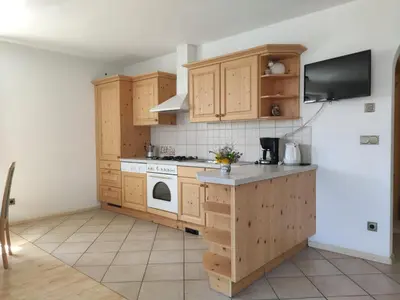 a kitchen with wooden cabinets and a stove top oven at Obkirchhof in Unsere Liebe Frau im Walde
