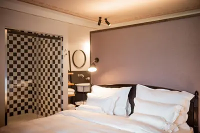 a bedroom with a large bed with white pillows at Castel Maurn Dolomites in San Lorenzo di Sebato