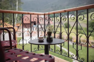 a table with a vase of flowers on a balcony at Castel Maurn Dolomites in San Lorenzo di Sebato