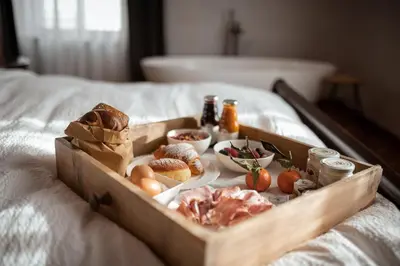 a wooden tray of food on a bed at Castel Maurn Dolomites in San Lorenzo di Sebato