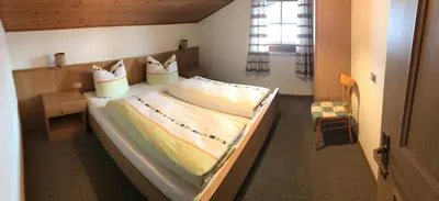 a bedroom with a large bed in a room at Campedèl Hof in Castelrotto