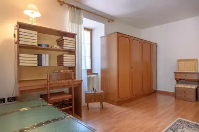 a living room with a desk and a book shelf at Appartamento Da Vittoria Valda Val di Cembra in Valda