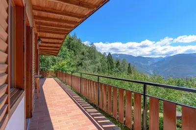 a balcony of a house with a view of the mountains at Al Faggio Ponciach Altavalle OSPITAR in Sover