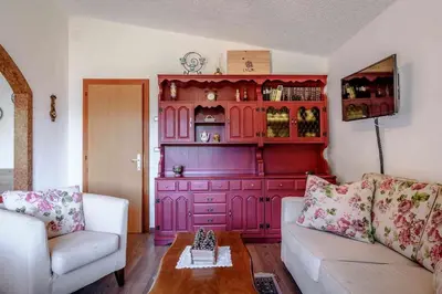 a living room with a large red hutch at Al Faggio Ponciach Altavalle OSPITAR in Sover