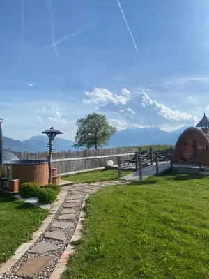 a garden with a stone path and a fence at Agritur Bella di Bosco in Coredo