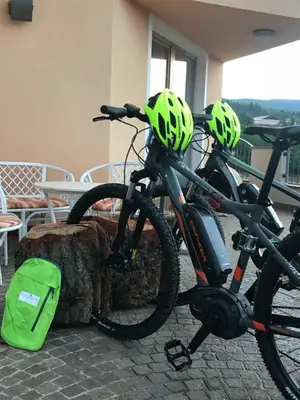 two bikes with helmets are parked next to a table at Agritur Bella di Bosco in Coredo