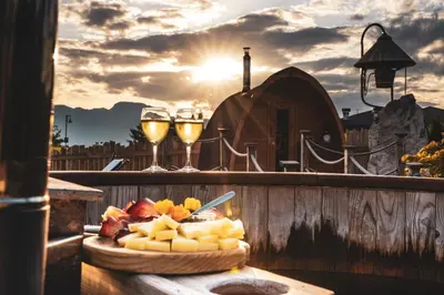 a plate of cheese and two glasses of wine at Agritur Bella di Bosco in Coredo