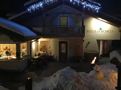 a house with a pile of snow in front of it at Agritur Bella di Bosco in Coredo
