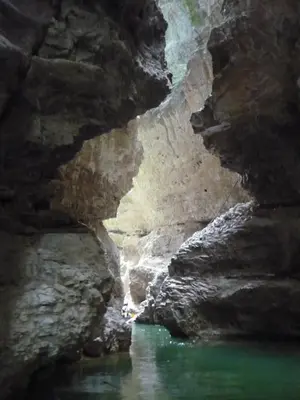 a cave with a pool of green water in it at Agritur Vista Lago in Revò