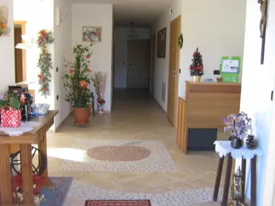 a living room with a hallway with plants in it at Agritur Vista Lago in Revò