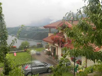 a house with a car parked in front of it at Agritur Vista Lago in Revò