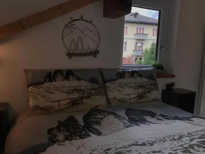 a bed with two pillows on it in a bedroom at The Bijoux - Dolomites in Agordo