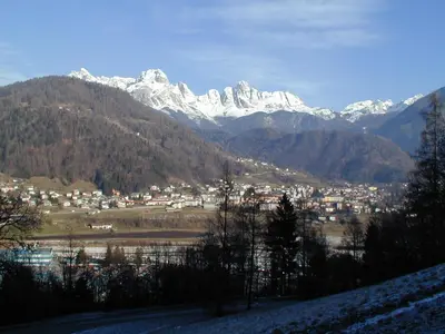 a view of a town with snow capped mountains at The Bijoux - Dolomites in Agordo