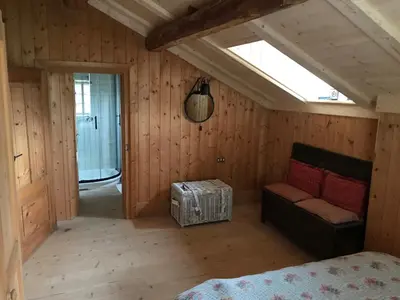 a room with a bed and a couch and a window at Cherz Romantic House in Arabba