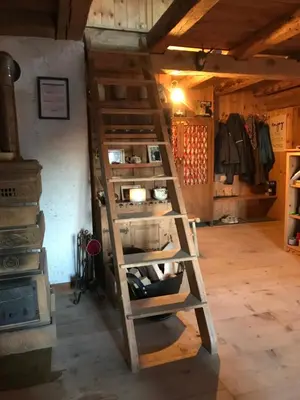 a wooden ladder in a room with a closet at Cherz Romantic House in Arabba