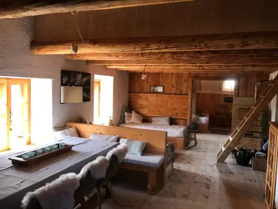 a large room with a bed and a table in it at Cherz Romantic House in Arabba