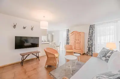 a living room with a couch and a table at Renoviertes Apartment mit Terrasse an der Piste mit kostenlosen WiFi in Carezza al Lago