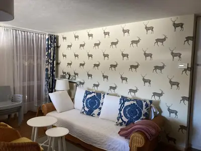 a bedroom with a wall with deer on it at Renoviertes Apartment mit Terrasse an der Piste mit kostenlosen WiFi in Carezza al Lago