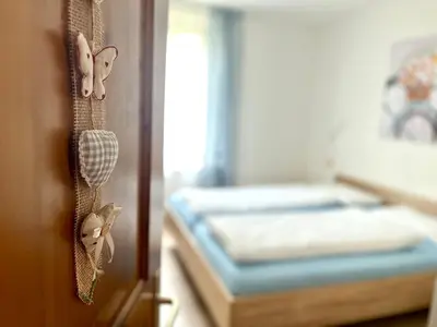 a bedroom with a bed and butterflies on the door at My Dolomites Home in Livinallongo del Col di Lana