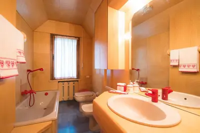 a bathroom with a sink and a tub and a toilet at Casa vacanze 5 Torri in Cortina dʼAmpezzo