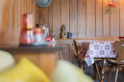 a kitchen with a table with a cloth on it at Casa vacanze 5 Torri in Cortina dʼAmpezzo
