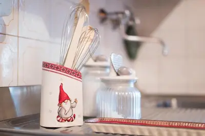 a cup with a gnome on it sitting on a counter at Casa vacanze 5 Torri in Cortina dʼAmpezzo