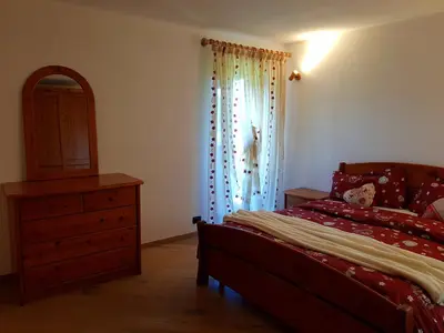 a bedroom with a bed and a dresser and a window at Casa sulle nuvole in Montesover
