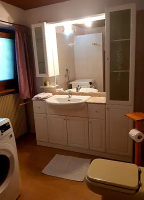 a bathroom with a sink and a large mirror at Casa sulle nuvole in Montesover