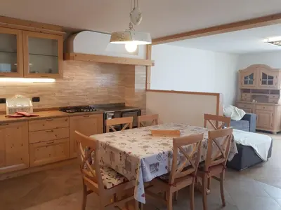 a kitchen with a table and chairs in a room at Casa sulle nuvole in Montesover