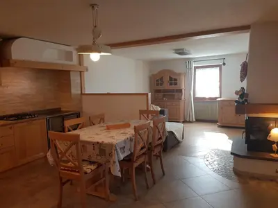 a kitchen and dining room with a table and chairs at Casa sulle nuvole in Montesover