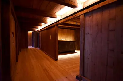 an empty room with wooden walls and a wooden floor at Haidnerhof in Bressanone